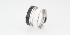 Macro shot of minimalist black and white couple rings with polished steel edges and inlay