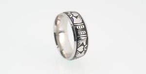 Macro shot of Irish Claddagh ring featuring hands heart and crown with antique finish