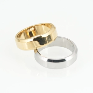 Sleek gold and silver titanium steel rings with beveled edges and polished finish