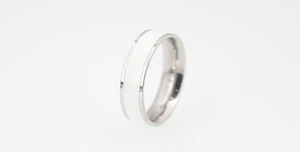 Close-up of a minimalist silver stainless steel ring with white lacquer inlay detail