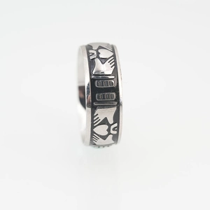 Polished titanium steel Claddagh ring featuring hands holding heart with black enamel inlay