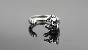 Macro detail of vintage tiger head ring with antique silver finish and carved textures