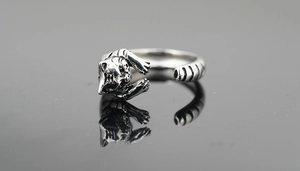Macro shot of retro stainless steel tiger ring with textured fur and oxidized finish details