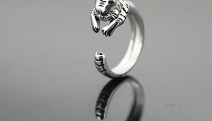 Detailed close-up of tiger head ring with vintage silver finish and character engraving