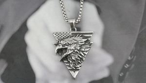 Detail of vintage silver eagle pendant with stars and stripes on a titanium steel necklace