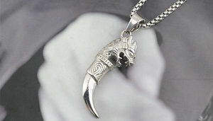 Close-up of titanium steel dragon head pendant with silver claw and box chain