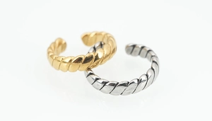 Detailed view of twisted rope rings in gold and silver finish with adjustable bands