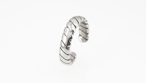 Detailed view of silver twisted rope ring texture and adjustable open band design