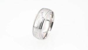 Detailed close-up of engraved floral patterns and S925 mark on silver steel ring