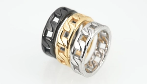 Detailed view of cuban link chain rings in black, gold, and silver finishes for men