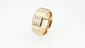 Detailed close-up of golden stainless steel ring featuring brushed finish and vertical stripes