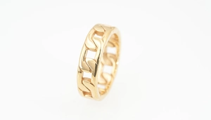 Macro view of a gold-plated Cuban chain link ring in a bold urban style for men and women