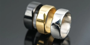 Macro view of geometric multi-faceted titanium steel rings in gold, silver and black