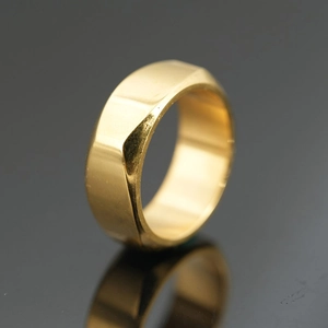 Polished gold stainless steel ring featuring a modern minimalist geometric faceted design