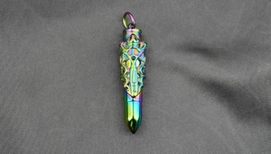 Macro detail of rainbow plated bullet pendant with intricate mechanical hollow carvings