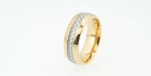 Macro view of gold stainless steel ring featuring textured carbon fiber inlay detail