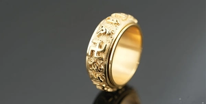 Macro detail of golden rotatable ring with religious mantra engraving and polished finish