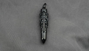Close-up of gothic dragon pattern bullet pendant in dark gray titanium steel metal