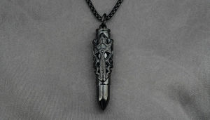 Detail of black bullet pendant with gothic relief carving and titanium wheat chain