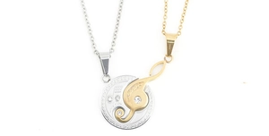 Detail of interlocking musical note pendants in silver and gold stainless steel