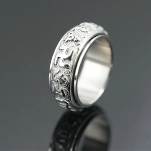 Vintage rotating stainless steel ring with embossed religious symbols and silver finish