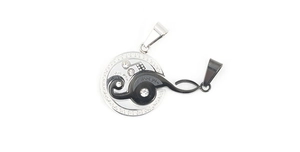Detail of interlocking stainless steel music note pendant with love you engraving and crystals