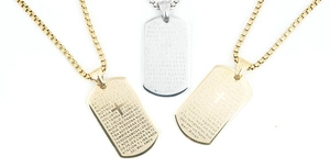 Close-up of titanium steel cross pendants with engraved Lord's Prayer in gold and silver