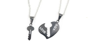 Detail of interlocking heart and key pendants with I LOVE YOU engraving for couples