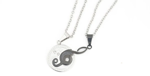 Detail view of puzzle heart necklace showing 'I love you' engraving and rhinestone inlay