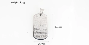 Macro shot of silver stainless steel dog tag pendant with engraved Lord's Prayer text