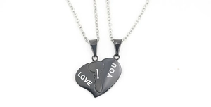 Detail showing interlocking black titanium heart pendant with I Love You engraving