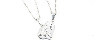 Detailed close-up of interlocking heart-shaped love you puzzle pendant necklaces