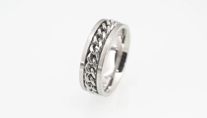 Detail shot of men's matte titanium ring featuring a polished rotatable Cuban chain inlay