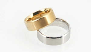 Macro detail of gold and silver titanium rings with brushed finish and beveled edges