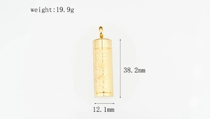 Detailed view of the 38.2mm gold-plated cylinder pendant with Buddhist engraving