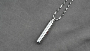 Macro view of cylinder stainless steel urn necklace with screw opening for men