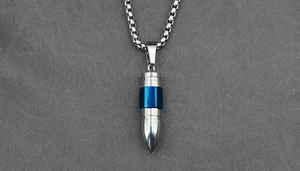 Detailed close-up of bullet-shaped titanium steel pendant with blue hexagon ring