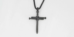 Close-up of black matte nail cross pendant with box chain on a clean white background