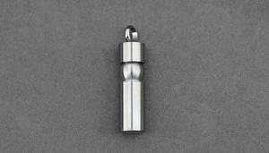 Close-up of silver stainless steel cylinder cremation pendant with matte brushed finish