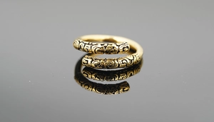 Macro view of gold adjustable ring featuring intricate vintage cloud patterns and textures