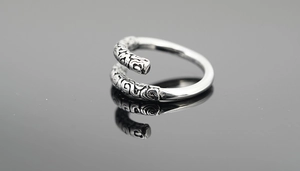Macro shot of retro silver ring with cloud patterns and vintage oxidized metal finish