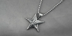 Macro shot of gothic star skull pendant with retro texture and silver box chain