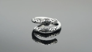 Macro detail of retro Sun Wukong ring with vintage patterns and silver finish