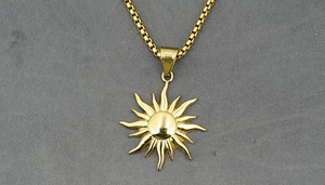 Detail showing a sunburst pendant in gold finish with box chain for men and women