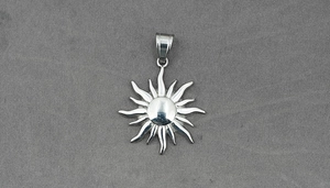 Macro shot of 316L stainless steel sun pendant with radiating rays and polished bail