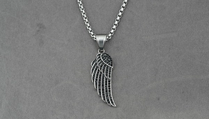 Close-up of silver single wing pendant encrusted with black rhinestones on box chain