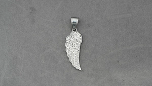 Detailed close-up of a silver angel wing pendant with shimmering pavé micro-zirconia stones