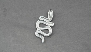 Detailed macro view of S-shaped silver rattlesnake pendant with shimmering crystals