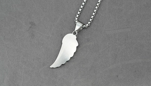 Detail of brushed silver feather pendant with box chain and punk minimalist design