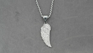 Macro shot of silver hip-hop feather pendant with pavé-set shimmering zircon stones